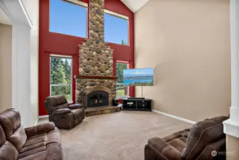 Family room w/ floor to ceiling wood burning fireplace