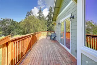 Large expansive deck extends from one side of the home to the other