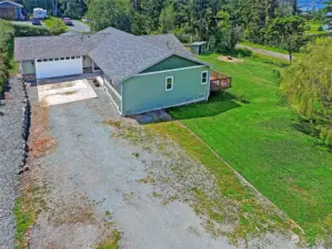 Large gravel driveway leading to the cement driveway gives you and your guests plenty of parking options