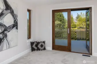 Primary Bedroom Doors to Deck Overlooking Lake