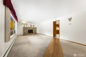Entry into formal living room features a path to the kitchen.