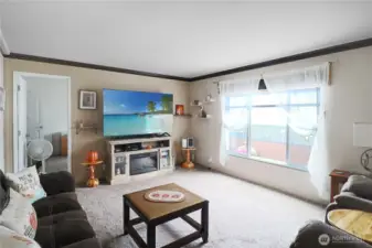 Spacious living room highlighted by a large picture window—bringing the outdoors in with abundant natural light.