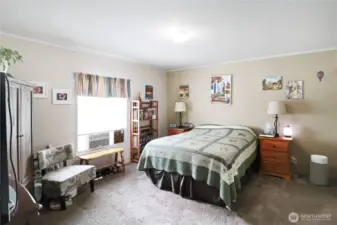 Spacious primary suite with room for a king bed, soft natural light, and private access to the en suite full bath and a great walk-in-closet.