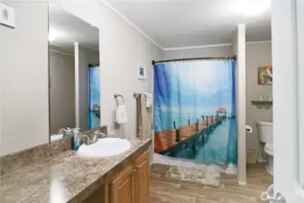 Private primary bath with generous vanity space, storage, and a tub for soaking