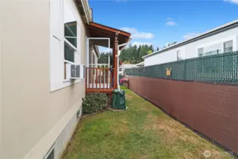 Covered front porch offers a welcoming entry, while the privacy fence provides seclusion for your outdoor space.