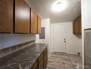 Functional laundry area with convenient access to outside and space for storage, space to make daily routines  efficient.