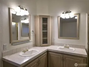 Dual sink vanity offering functional counter space and storage.