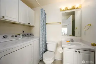 Hall bathroom with shower and washer and dryer