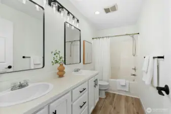 Main level bath that opens to the bedroom and hall