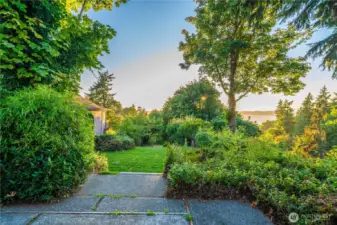 the patio and stairs lead to the back lawn and the garden area