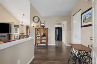 As you step into the entry, the living room is to the left with the kitchen and dining room straight ahead. To the right is the door to the laundry room, and out to the garage.