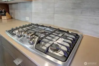 5-burner, stainless steel cooktop.