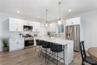 Very functional kitchen with a lot of storage space.  The closed door is the entrance to a walk-in pantry.