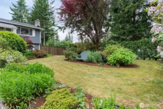 Gorgeous, mature, landscaping makes the front yard look like a park