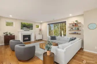 The gas fireplace anchors the living and dining spaces while well-placed windows maximize the greenbelt views.