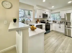 Kitchen with bar height countertop for a relaxing breakfast and coffee.