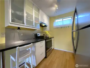 Recently updated kitchen includes stainless steel appliances and solid surface counters.