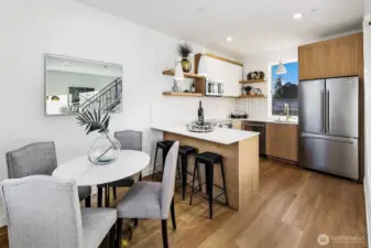 Dining space easily seats 4 with space even for 3 bar stools at the kitchen island and countertop.