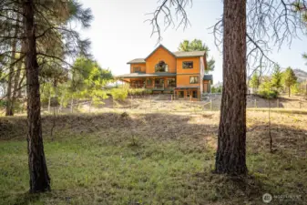 Overlooking open grassy meadow and Methow river.
