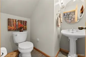 Main floor guest powder room/bathroom off foyer.