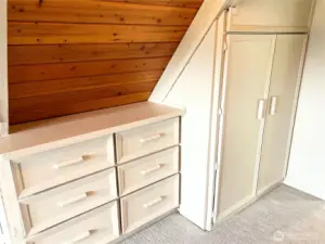 Upstairs bedroom with original built-ins and extra storage.