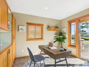 This custom flex space serves as a secondary entrance to the home and features custom built in storage and blinds. It seamlessly connects to the rest of the house, offering both functionality and style.