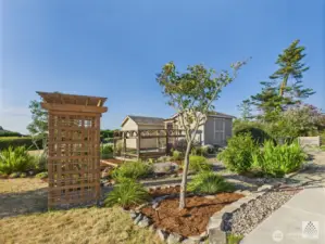 The garden space includes a fenced area and a custom shed, providing protection for flowers and vegetable from the deer while keeping everything organized and accessible.