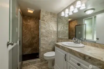 primary bathroom with walk in shower and bench