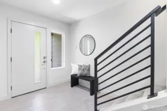 Covered entry on ground level opens to bright foyer with durable tiled floor.