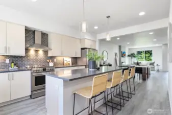 Main floor features well-equiped kitchen with stainless steel appliances, gas cooktop, overhead fan vent and tons of storage.