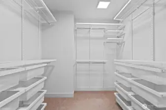Walk-in closet has been upgraded with Elfa closet system featuring adjustable shelves and drawers.