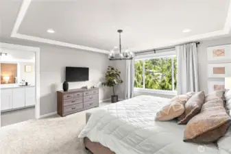 Primary suite with walk-in closet and lighted panel ceiling