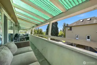 Deck off the living room of the house.  Duplex on the right
