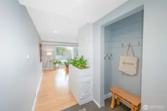 Main floor is full of light, newer hardwood floors and MCM architectural details like the brick built-in planter.