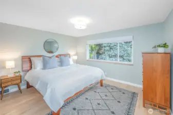 Primary bedroom on main overlooks the front garden. King size bed fits no problem!