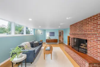 Lower level rec room with cork flooring, wood fireplace and sunny south east windows.
