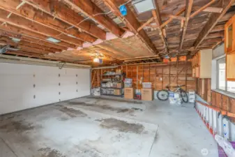 Two car garage has a permitted sub-panel.