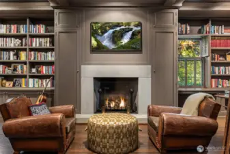 Take a meeting or cozy up to the fire with a nearby book in the library featuring a wet bar, refrigerator, wood burning fire with gas starter, storage for all.