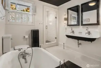 Bathroom with separate shower, dual sink and clawfoot tub.