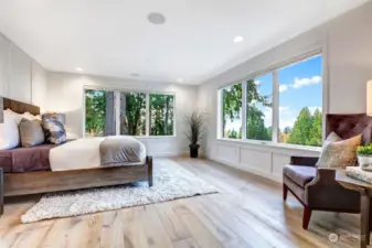 Light and bright primary bedroom is luxurious and offers pleasant Lake Washington and Olympic Mountain views!