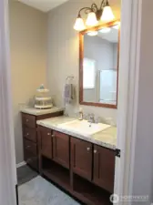 BATHROOM NEXT TO MASTER HAS GOOD STORAGE.