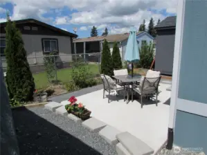 FINISHED CEMENT PATIO BEHIND HOME.