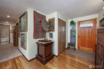 Entry way with bamboo floors and coat closet.
