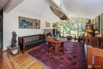 Natural light filled living room with vaulted ceilings, picture windows, bamboo floors and wood burning fireplace.