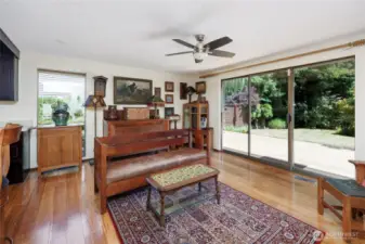 Generous family room with bamboo floors, wet bar, wood burning fireplace and oversized slider that steps out to the new deck with seating bench.