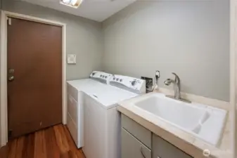 Laundry room with utility sink. Washer and dryer stay.