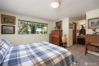 Primary suite has updated 3/4 bath and cedar lined walk in closet.
