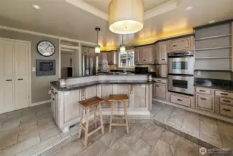 Kitchen, showing off the large vast of it.  Double doors lead you to the walk - in pantry