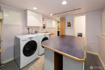 Laundry room is downstairs with plenty of folding space and storage.
