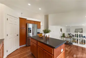 There is a pantry through the white door. Watch TV in the lower family room while you cook!